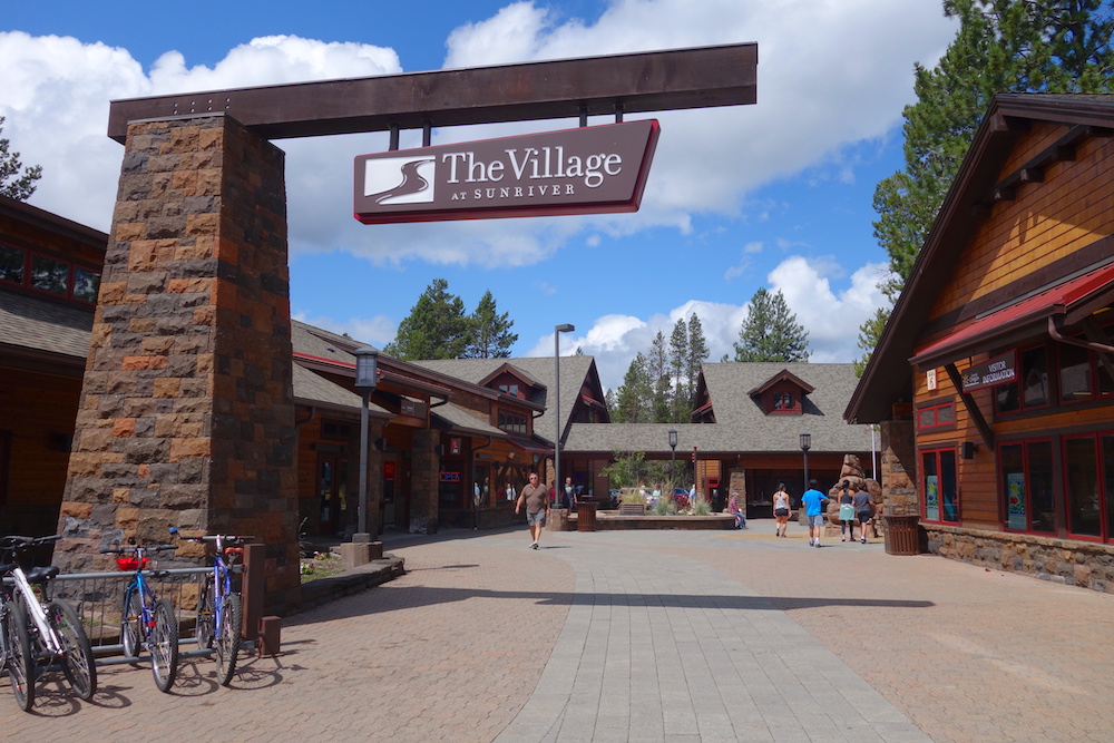 Sunriver Village entrance with shops and trees in background