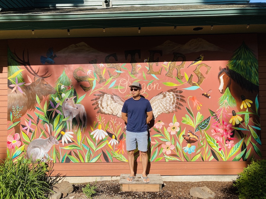 J in front of instagrammable mural in sisters oregon