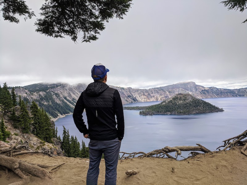 Jedd standing above looking out at Crater Lake